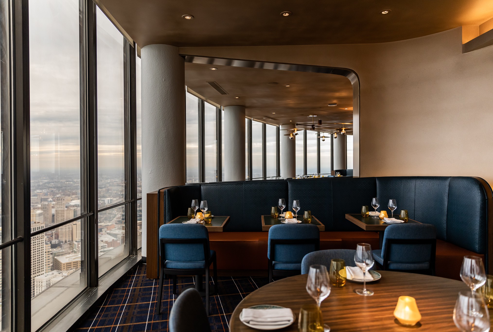 A blue upholstered banquette inside the Highlands.