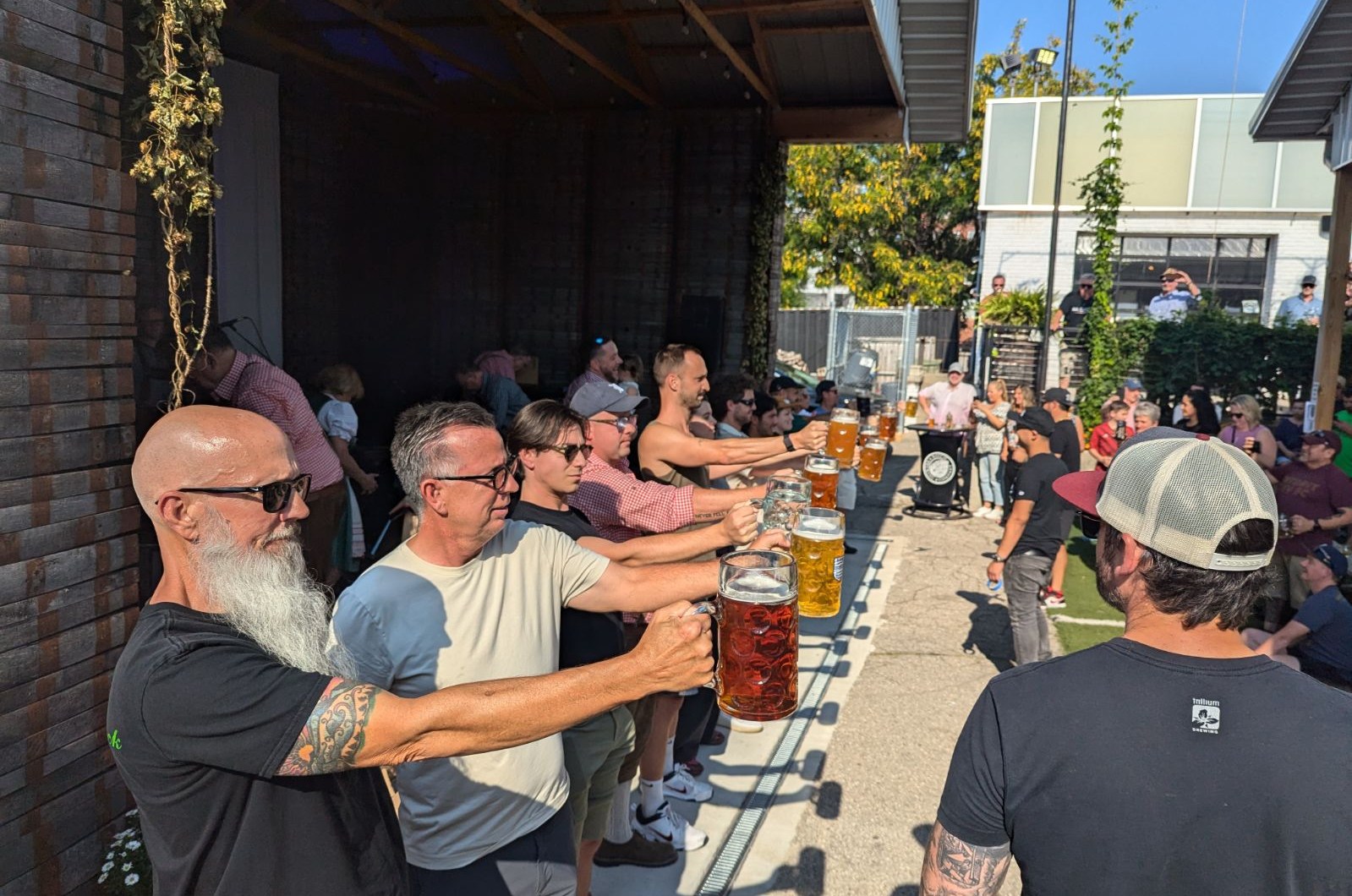 Competitors hoisting steins for Oktoberfest.