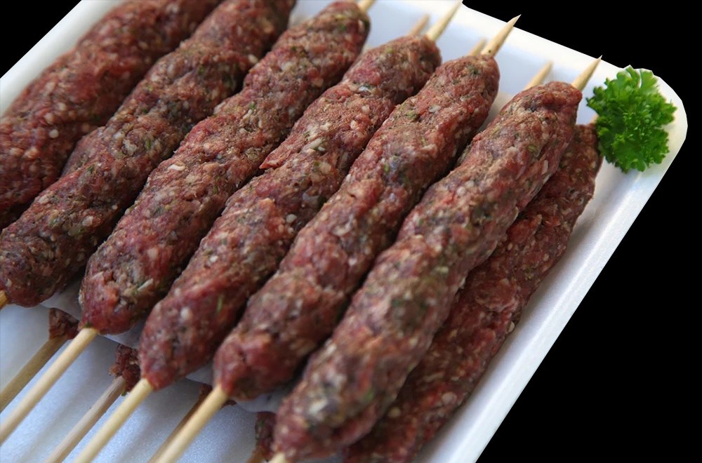 Skewers of raw beef kafta.