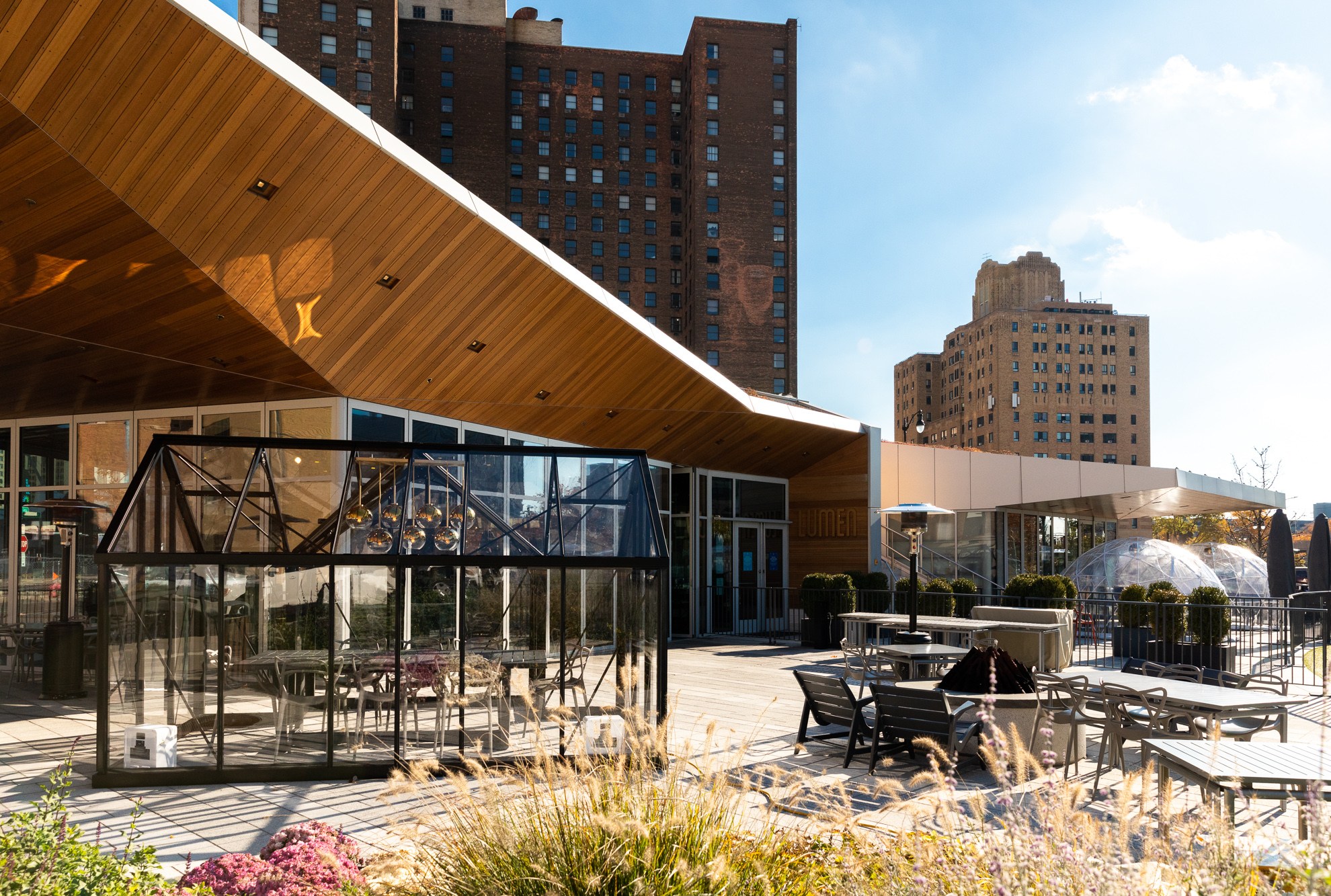 Geodesic domes and glass dining enclosures stand outside of Lumen in Detroit on a sunny fall day.