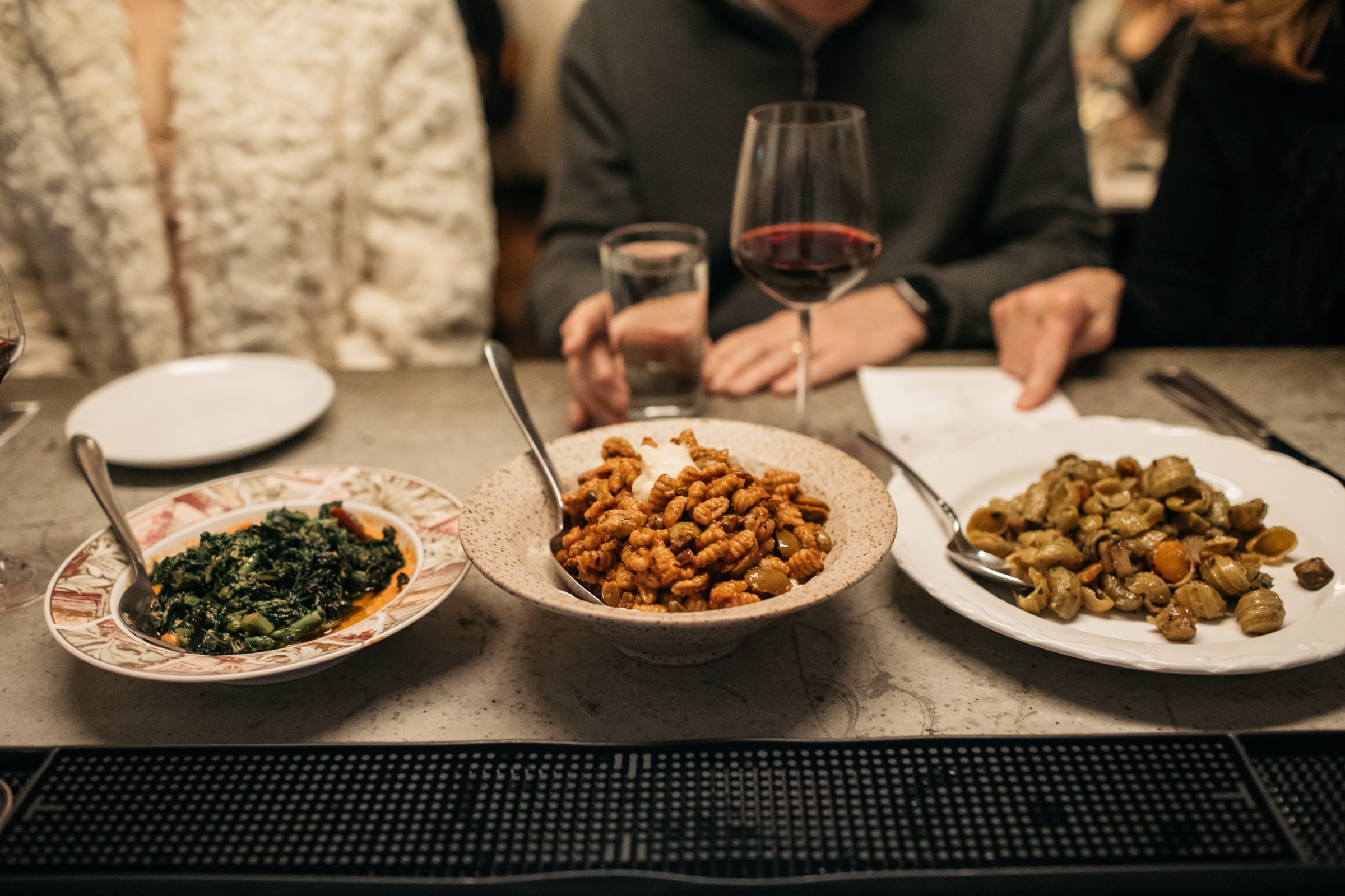 Three plates of pasta.