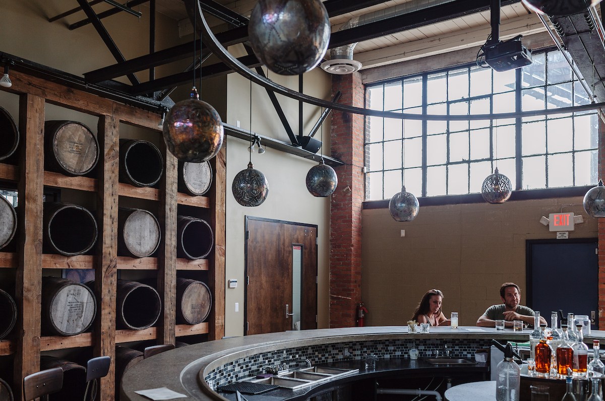 Two customers sit at the circular bar inside Two James.